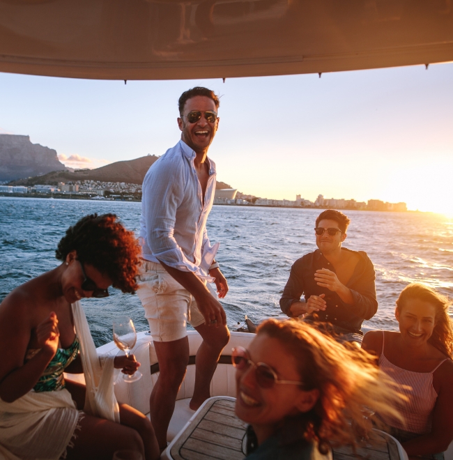 Friends chatting on a yacht deck at sunset